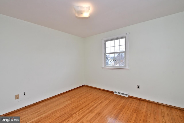 unfurnished room with light hardwood / wood-style floors