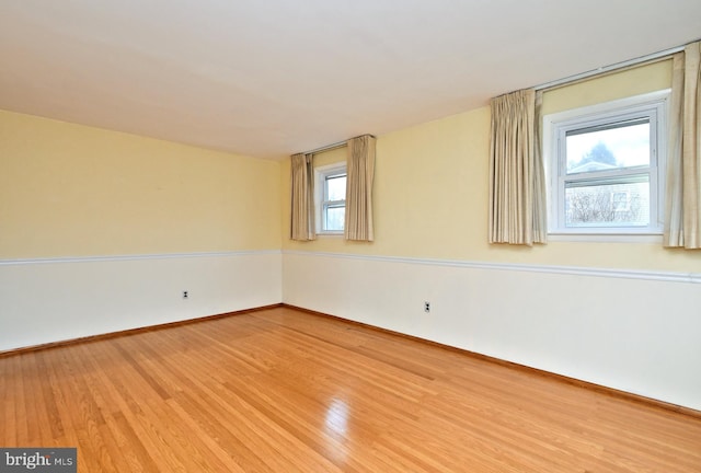 spare room with wood-type flooring