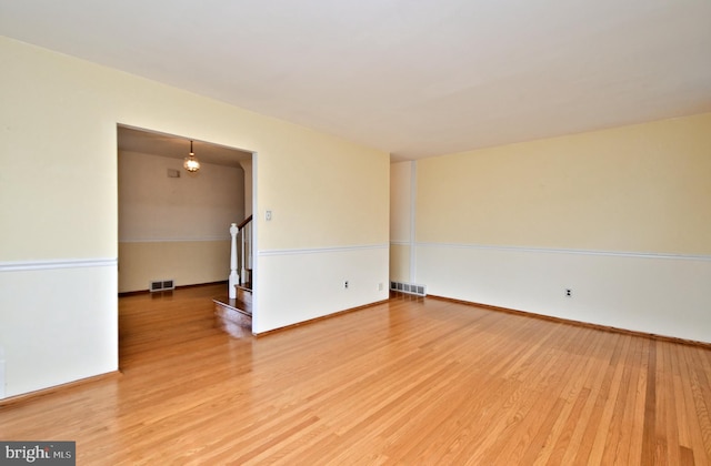 unfurnished room with hardwood / wood-style flooring