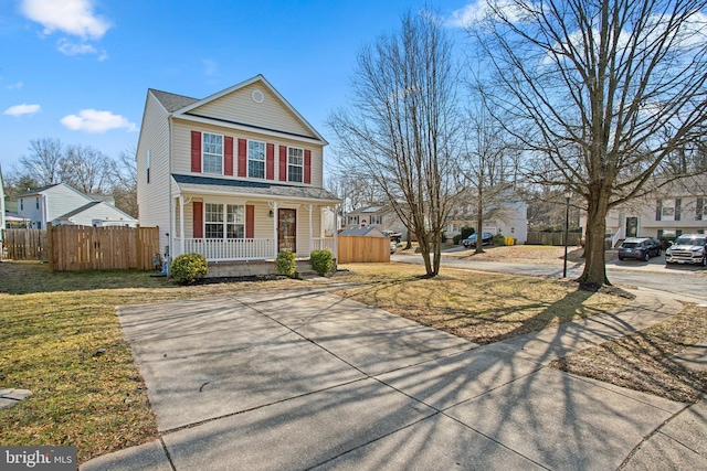 view of front property featuring a porch and a front yard