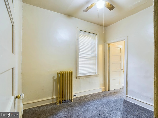 carpeted spare room with radiator heating unit and ceiling fan