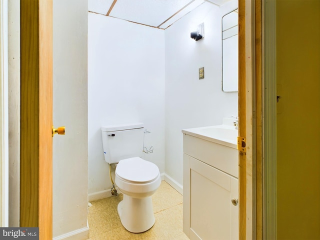 bathroom featuring vanity, toilet, and tile patterned flooring