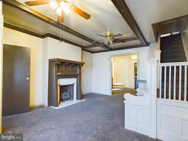 unfurnished living room with beamed ceiling, ceiling fan, and dark carpet