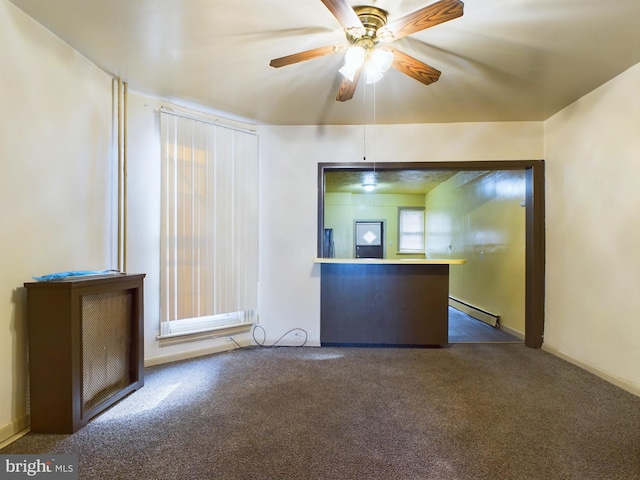 kitchen with baseboard heating, ceiling fan, and dark colored carpet