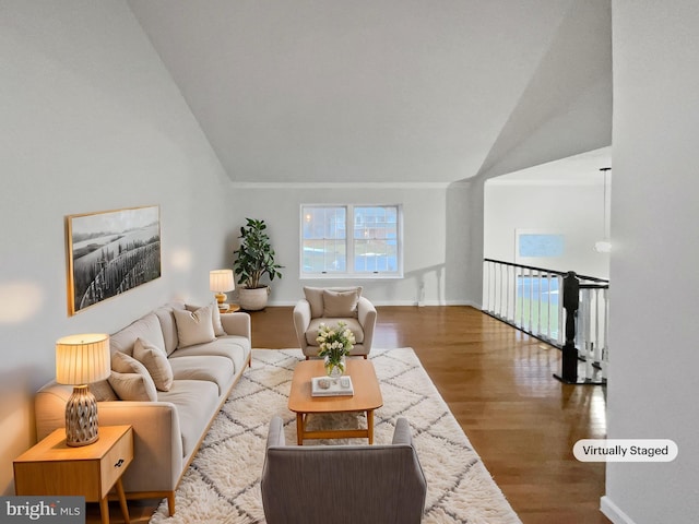 living room featuring lofted ceiling and hardwood / wood-style floors