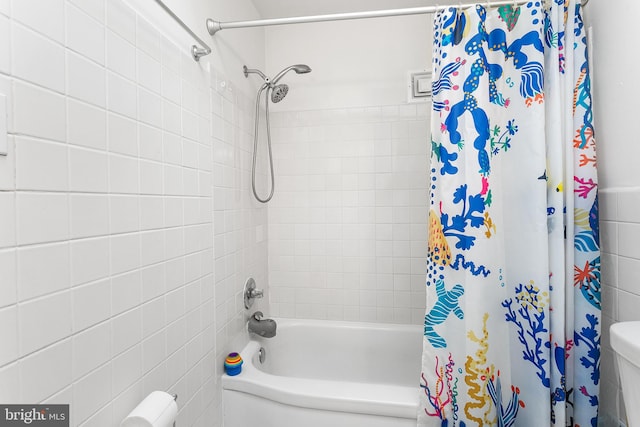 bathroom with toilet and shower / bath combo with shower curtain