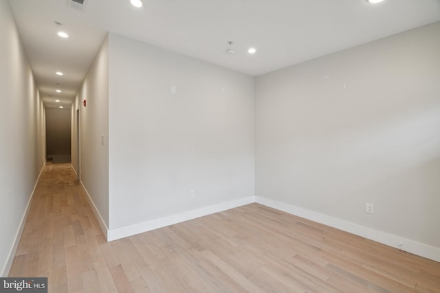 empty room with light hardwood / wood-style flooring