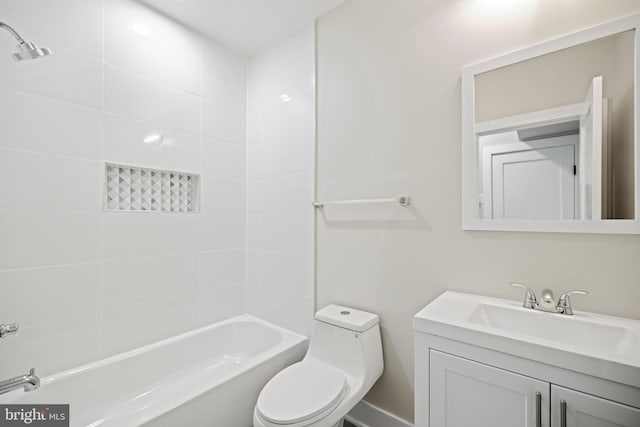 full bathroom with vanity, tiled shower / bath, and toilet