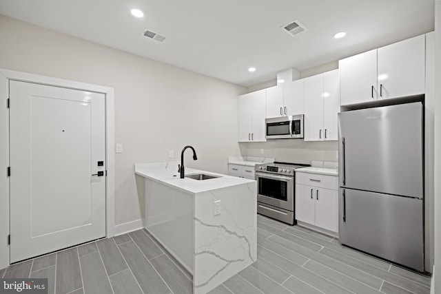 kitchen featuring white cabinetry, appliances with stainless steel finishes, and sink