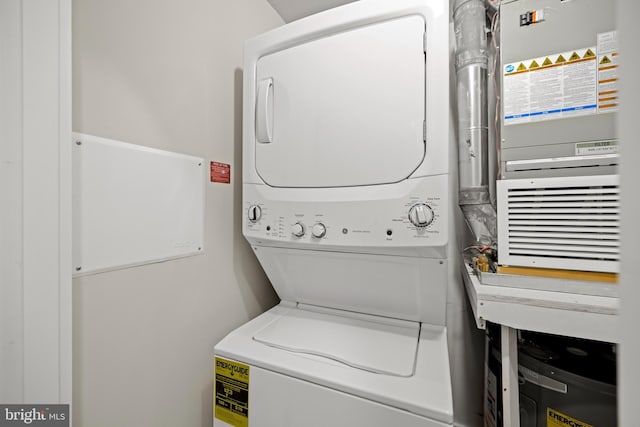 washroom featuring stacked washer and clothes dryer