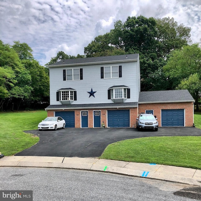 front of property featuring a garage and a front lawn