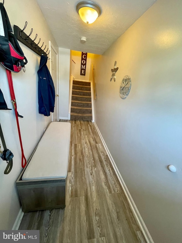 hall featuring hardwood / wood-style flooring and a textured ceiling