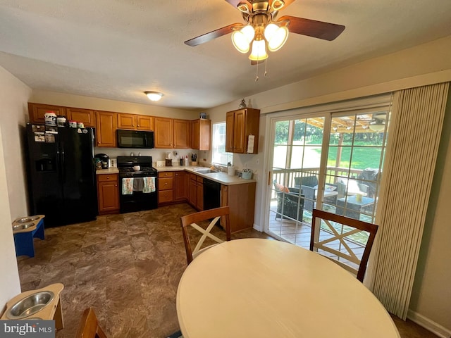 kitchen featuring ceiling fan, sink, and black appliances