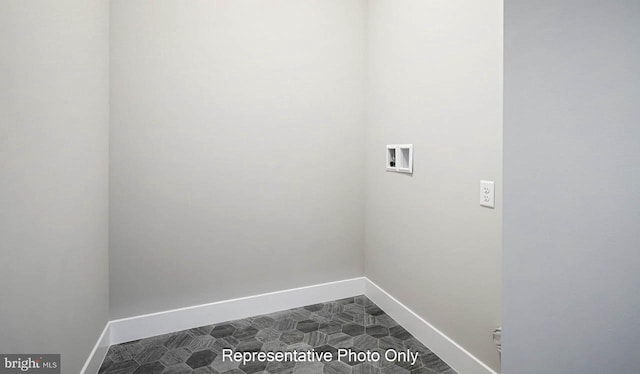 washroom with laundry area, hookup for a washing machine, baseboards, and dark floors