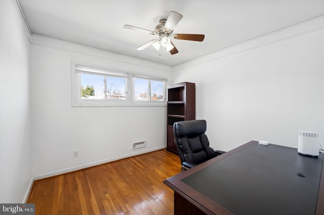 home office with hardwood / wood-style floors, crown molding, baseboards, and ceiling fan