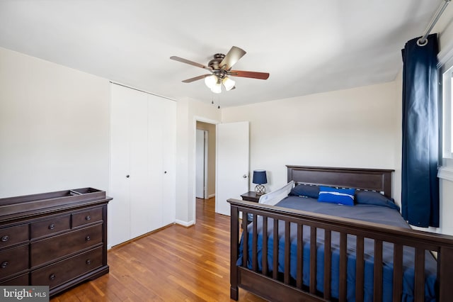 bedroom with a closet, ceiling fan, and wood finished floors