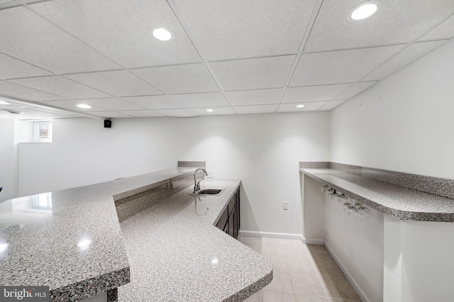 bar with a sink, a drop ceiling, and recessed lighting