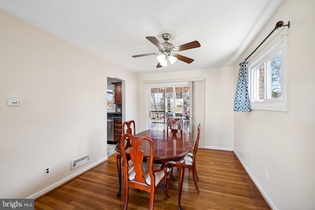 dining area featuring visible vents, a healthy amount of sunlight, baseboards, and wood finished floors