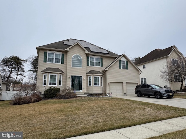 front of property with a garage, a front yard, and solar panels