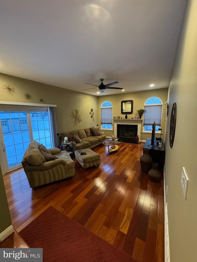 living room featuring hardwood / wood-style flooring, ceiling fan, and a wealth of natural light