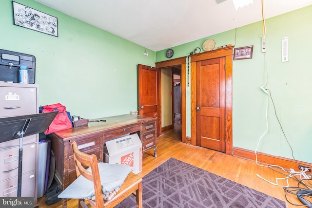 interior space featuring baseboards and wood finished floors