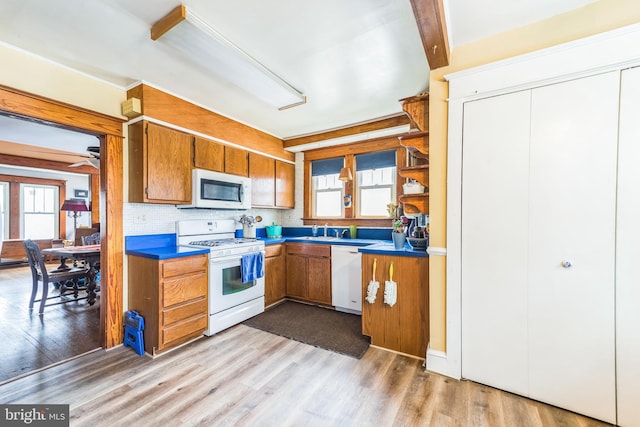 kitchen featuring a healthy amount of sunlight, white appliances, and light wood-style flooring