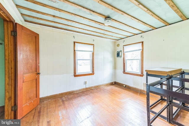 interior space with hardwood / wood-style floors and wood walls
