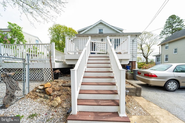 exterior space with stairway and a wooden deck