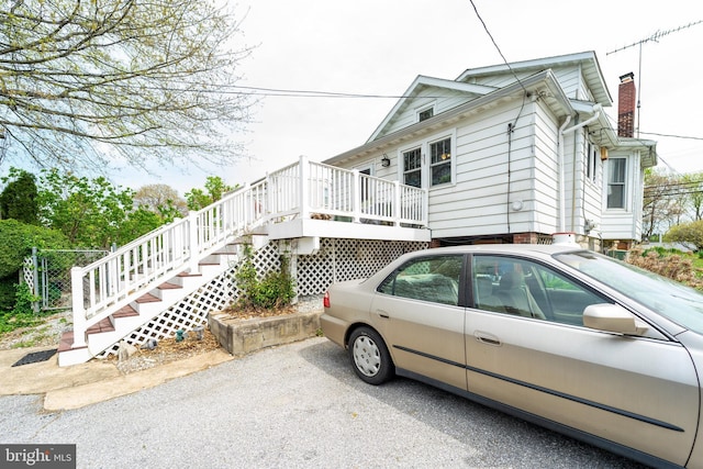 view of home's exterior featuring a wooden deck and stairs