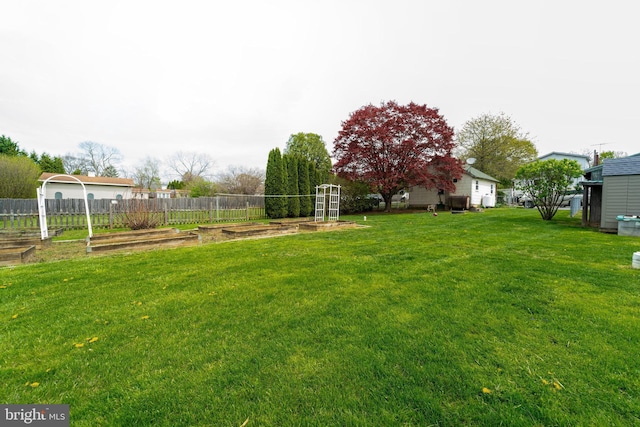 view of yard featuring a vegetable garden and fence