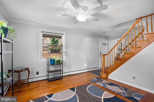 foyer with ornamental molding, stairway, baseboards, and wood finished floors