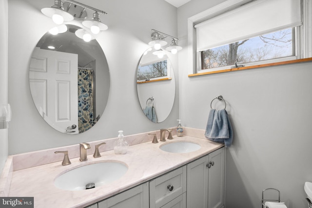 full bath with a sink and double vanity