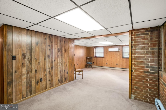 below grade area with light carpet, wood walls, and baseboard heating