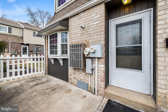 property entrance featuring brick siding