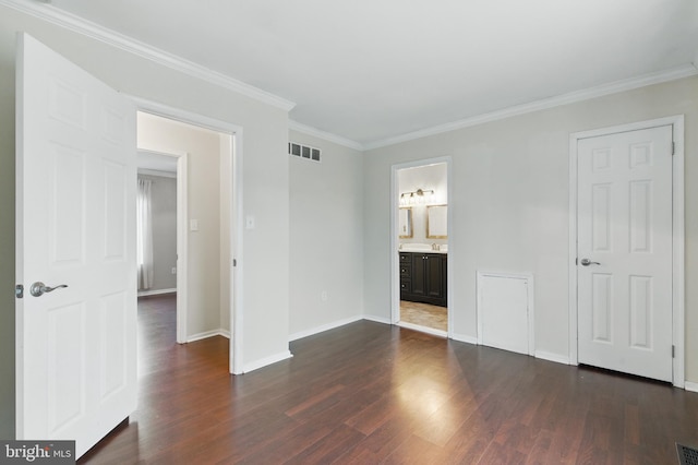 unfurnished bedroom featuring crown molding, dark wood-style floors, visible vents, and baseboards