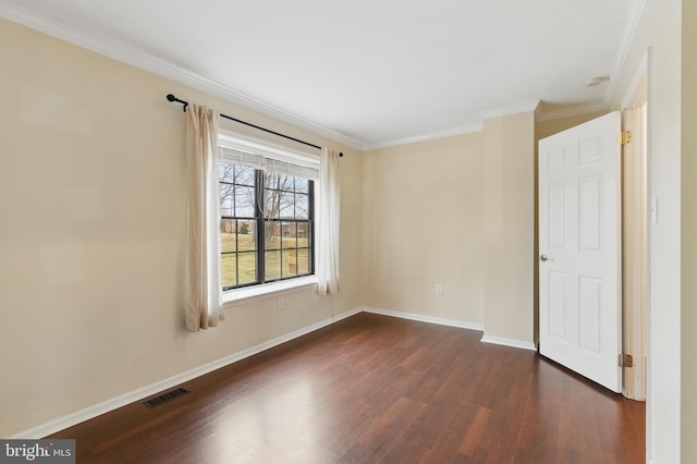 empty room with dark wood-type flooring, baseboards, visible vents, and ornamental molding