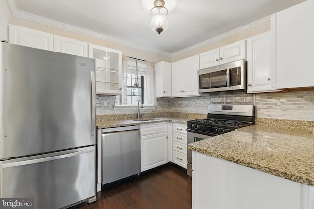 kitchen featuring white cabinetry, dark wood-style flooring, appliances with stainless steel finishes, and ornamental molding