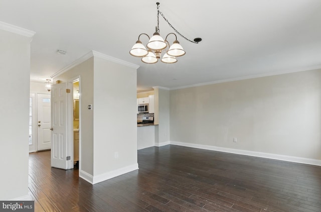 unfurnished living room with baseboards, dark wood-type flooring, a chandelier, and ornamental molding