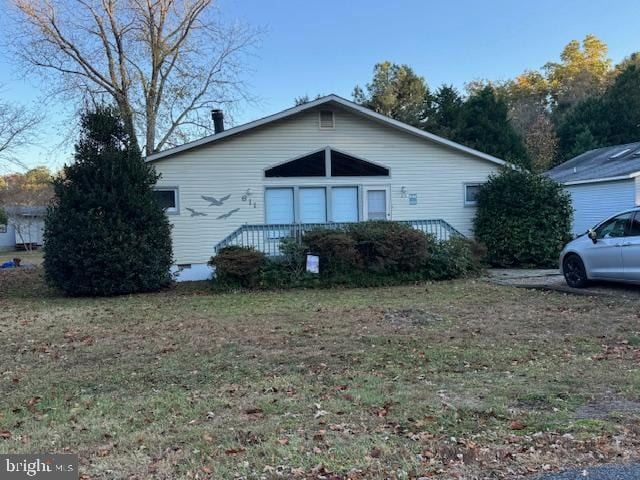 view of side of property with a yard