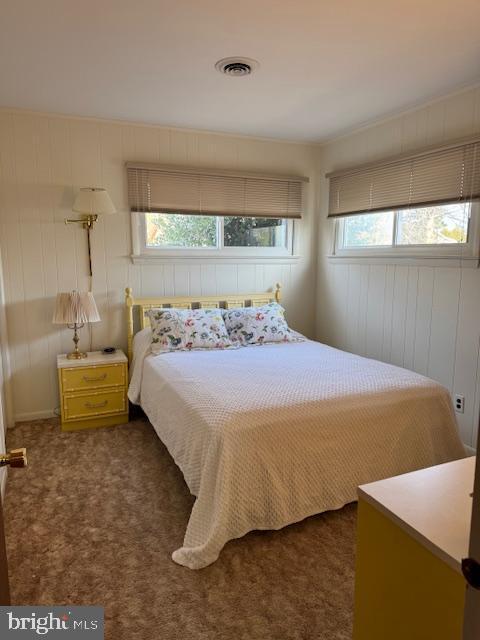 bedroom with dark colored carpet