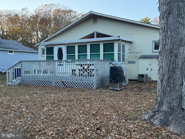 rear view of house with a wooden deck