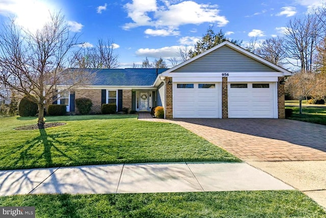 single story home featuring a garage and a front yard