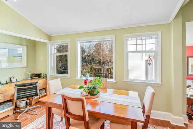 dining area featuring wood-type flooring, lofted ceiling, and a wealth of natural light