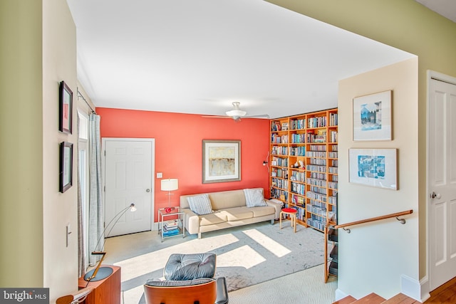 carpeted living room with ceiling fan