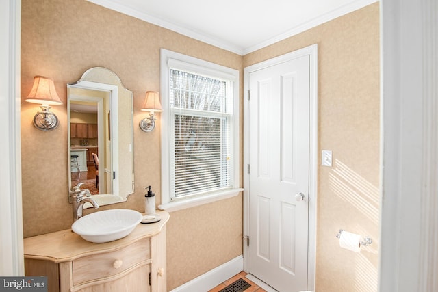 doorway featuring ornamental molding and sink