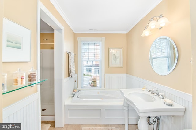 bathroom featuring ornamental molding and shower with separate bathtub