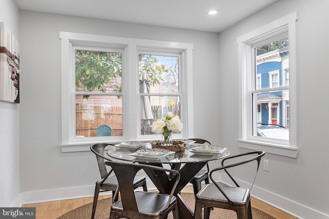 dining area with hardwood / wood-style floors and a healthy amount of sunlight