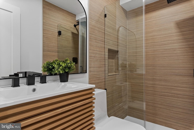 bathroom with vanity, an enclosed shower, and toilet