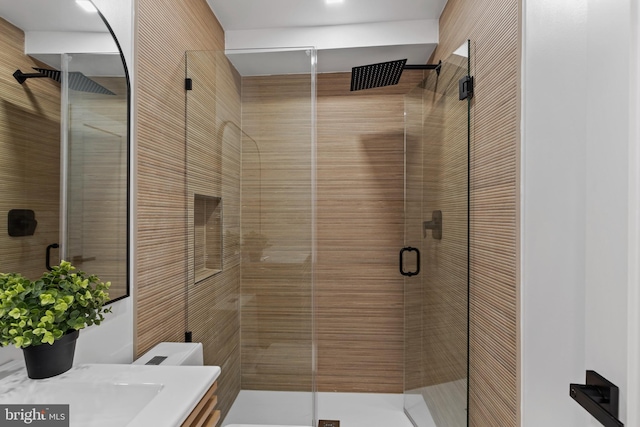 bathroom featuring walk in shower, vanity, and toilet