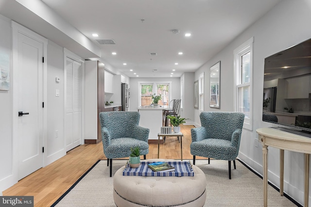 sitting room featuring light hardwood / wood-style flooring